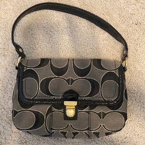 Black, gray, gold coach purse. Small scratch shown on buckle in picture.